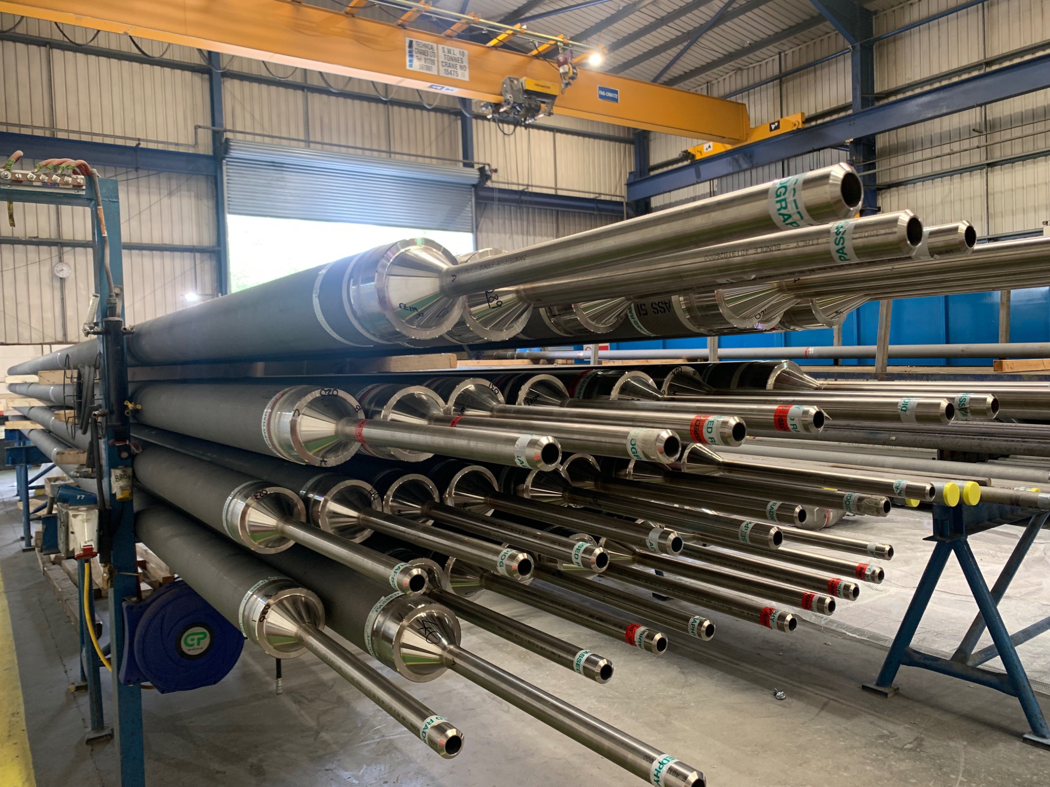 Rows of tube assemblies with reducers and smaller connecting tubes in a manufacturing workshop