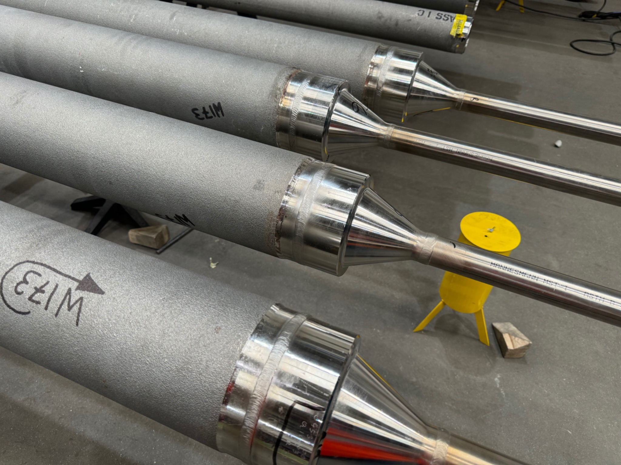 Close view of tube ends joined to polished reducers and smaller tubes
